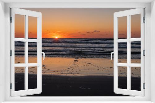 Fototapeta Naklejka Na Ścianę Okno 3D - Beautiful sunset landscape at the North sea and orange sky above it with awesome sun golden reflection on waves as a background. Amazing summer sunset view on the beach.