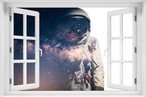 Fototapeta Naklejka Na Ścianę Okno 3D - The double exposure image of the astronaut's suit overlay with the milky way galaxy image. the concept of imagination, technology, future, and gaming.