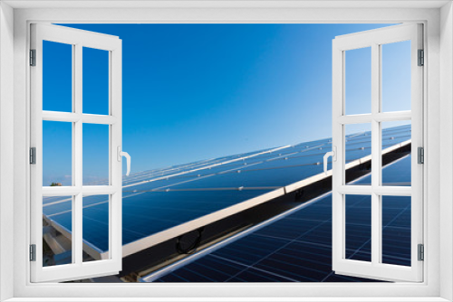 Fototapeta Naklejka Na Ścianę Okno 3D - Solar panels and blue sky background.Solar cells farm on the roof.Photovoltaic modules for renewable energy.Save the earth and the energy with good environment concept.