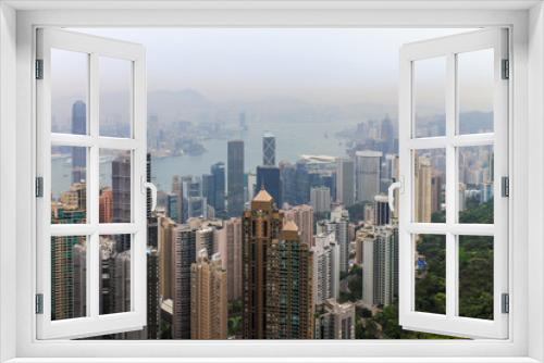 Fototapeta Naklejka Na Ścianę Okno 3D - View on Skyscrapers with Victoria Bay, Transportation Ships, Harbour and Kowloon taken from Hongkong Island Peak. Hong Kong, China