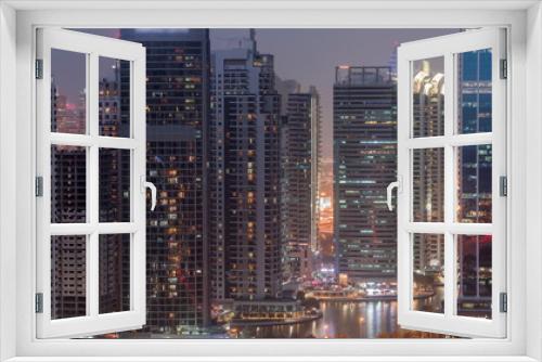 Fototapeta Naklejka Na Ścianę Okno 3D - Residential and office buildings in Jumeirah lake towers district day to night timelapse in Dubai
