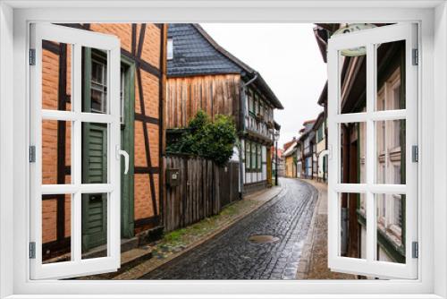 Fototapeta Naklejka Na Ścianę Okno 3D - Medieval street in the old town of Wernigerode (Harz/Germany) on a rainy da