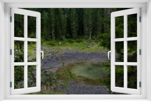 Fototapeta Naklejka Na Ścianę Okno 3D - Picturesque peaks of Dolomites mountains in reflection of crystal clear pond surrounded by coniferous forest. Lake of Caresse in Italy. Scenic place and famous touristic destination. Primeval nature