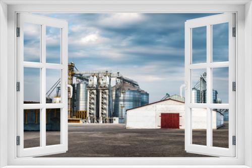 Fototapeta Naklejka Na Ścianę Okno 3D - agro-processing and manufacturing plant for processing and silver silos for drying cleaning and storage of agricultural products, flour, cereals and grain. Granary elevator