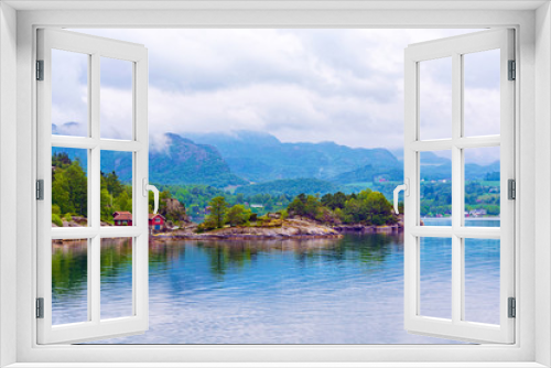 Fototapeta Naklejka Na Ścianę Okno 3D - Beautiful landscape of the fjord Lysefjord in Norway. A small traditional Scandinavian village on the picturesque coast of the fjord between the mountains. Travel background