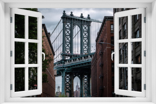 Fototapeta Naklejka Na Ścianę Okno 3D - View of one of the towers of the Manhattan Bridge from the streets of the DUMBO district, Brooklyn, NYC 