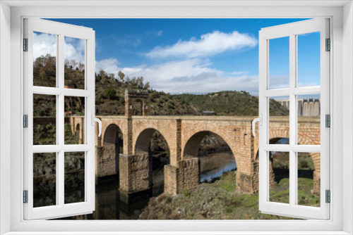 Fototapeta Naklejka Na Ścianę Okno 3D - The Puente de Alcantara, a Roman arch bridge in Toledo, Catile-La Mancha, Spain, spanning the Tagus River. The word comes from Arabic bridge