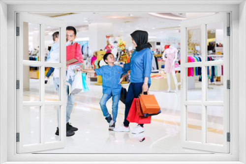 Family enjoying leisure time with shopping in mall