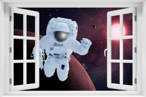 Fototapeta Naklejka Na Ścianę Okno 3D - Astronaut in orbit of the red planet. Elements of this image were furnished by NASA.