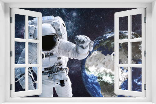 Fototapeta Naklejka Na Ścianę Okno 3D - Astronaut near Earth planet of solar system Closeup. Outer space journy. Science fiction. Elements of the image were furnished by NASA