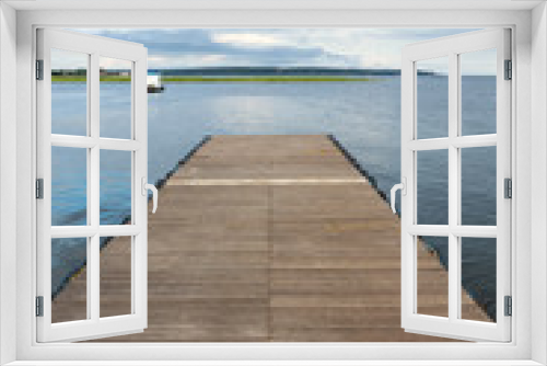 Fototapeta Naklejka Na Ścianę Okno 3D - Wooden pier on sunny summer day with boats and forest in the background on Rio Tapajos, Para state, Brazil. Concept of leisure, vacation, travel, tourism and mindfulness.