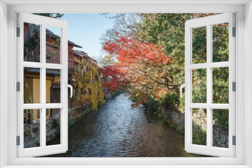 Fototapeta Naklejka Na Ścianę Okno 3D - Traditional street view in Gion with historical buildings and a river surrounded by red maple leaves, Higashiyama