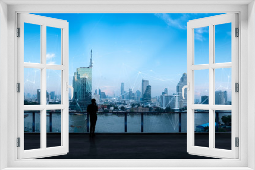 Fototapeta Naklejka Na Ścianę Okno 3D - Businessman standing using smart phone in modern space watching city night view.Business Wireless network and Connection technology concept.
