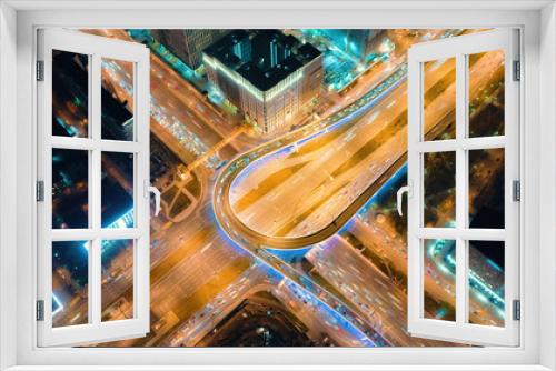 Fototapeta Naklejka Na Ścianę Okno 3D - Beautiful motion of the big road junction on the night, view from above. Aerial shot of busy crossroad in Moscow center with a lot of traffic and glittering city lights.