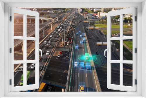 Fototapeta Naklejka Na Ścianę Okno 3D - Beautiful aerial presentation of the autonomous cars self-driving concept on multi-level highway in Moscow. Picturesque aerial panorama of the road traffic in a big city on the evening.