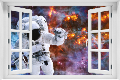 Fototapeta Naklejka Na Ścianę Okno 3D - Astronaut near exploding planet somewhere in deep space. Dramatic Apocalyptic Background Burning. Elements of this image were furnished by NASA
