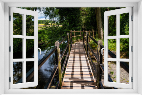Fototapeta Naklejka Na Ścianę Okno 3D - wooden footbridge on footpath through forest
