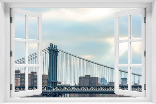 Fototapeta Naklejka Na Ścianę Okno 3D - The Manhattan Bridge is a suspension bridge that crosses the East River in New York City, connecting Lower Manhattan with Downtown Brooklyn.