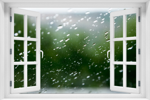 Fototapeta Naklejka Na Ścianę Okno 3D - Natural background Drops on both sides of the glass from the rain and from the fogging abstract view, raindrops against the blue glass and the blurred landscape of the gradient of blue and green
