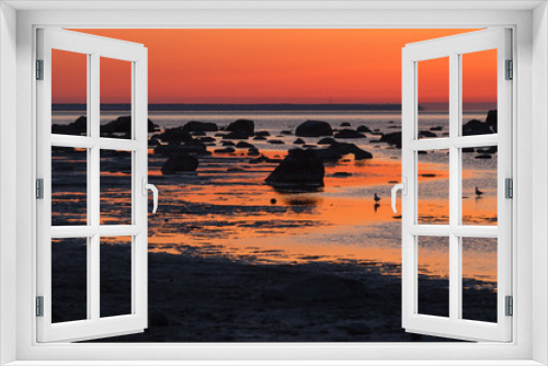 Fototapeta Naklejka Na Ścianę Okno 3D - Summer sunset over rocky shore of Baltic sea with silhouettes of stones and birds
