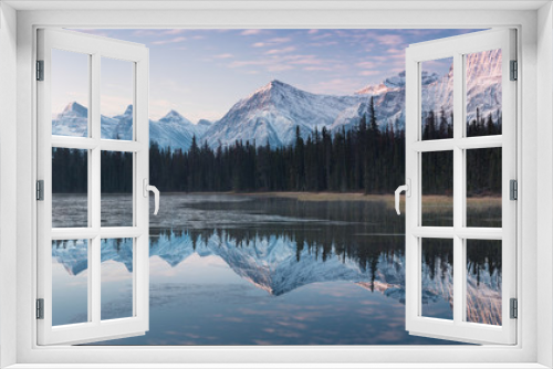 Fototapeta Naklejka Na Ścianę Okno 3D - Almost nearly perfect reflection of the Rocky mountains in the Bow River. Near Canmore, Alberta Canada. Winter season is coming. Bear country. Beautiful landscape background concept.