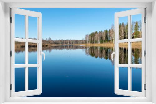 Fototapeta Naklejka Na Ścianę Okno 3D - peaceful landscape with trees reflections in the still lake waters on  sunny autumn morning, latvia