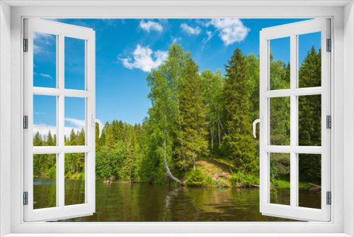 Fototapeta Naklejka Na Ścianę Okno 3D - The Bank of the forest river with forest, birch trees hanging over the water, blue sky with clouds.