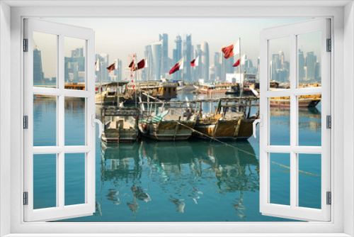 Fototapeta Naklejka Na Ścianę Okno 3D - Old wooden boats (dhows) with Qatari flags in Doha Harbor - Doha, Qatar 