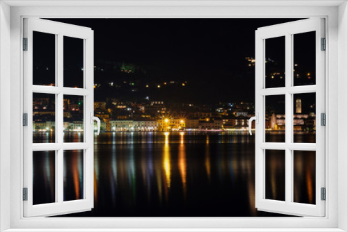 Fototapeta Naklejka Na Ścianę Okno 3D - Evening panoramic view of the center of Salo Lake Garda. City night lights reflected in water