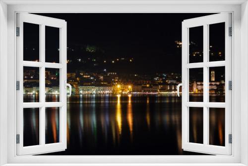Fototapeta Naklejka Na Ścianę Okno 3D - Evening panoramic view of the center of Salo Lake Garda. City night lights reflected in water