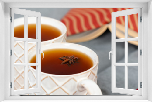 Fototapeta Naklejka Na Ścianę Okno 3D - Close up shot of a cups of tea on wooden board at a Christmas interior