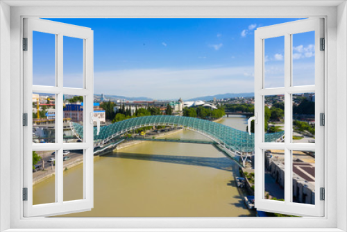 Fototapeta Naklejka Na Ścianę Okno 3D - Bridge of Peace in Tbilisi, Geaorgia, bow-shaped pedestrian bridge over the Kura River in Tbilisi, capital of Georgia. One of the most important sites of Tbilisi