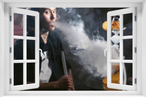 Fototapeta Naklejka Na Ścianę Okno 3D - Portrait of man smoking traditional hookah pipe and making smoke clouds with shisha. Man exhaling smoke in hookah cafe or lounge