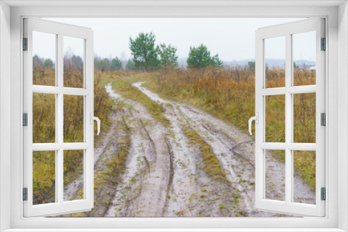 Fototapeta Naklejka Na Ścianę Okno 3D - Photography of Russian country road in rainy day. Autumn landscape in Moscow region. Concepts of travel and touristic mood and beauty of nature in bad weather.