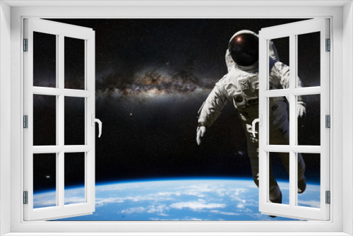 Fototapeta Naklejka Na Ścianę Okno 3D - astronaut during spacewalk in outer space 