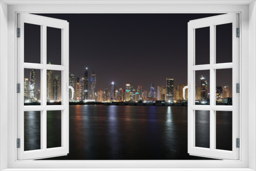 Fototapeta Naklejka Na Ścianę Okno 3D - Dubai skyline at night with lights reflections on the Gulf 