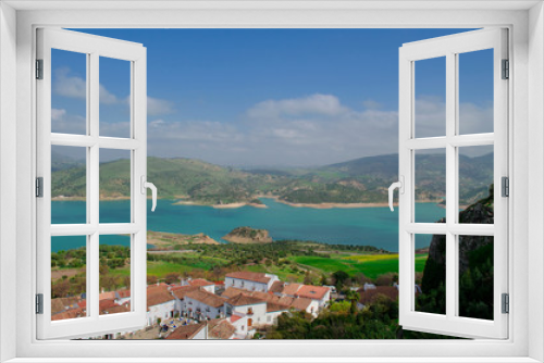 Fototapeta Naklejka Na Ścianę Okno 3D - View of the lake of Zahara de la Sierra and its white village. Whitewashed walls and red or brown tiled roofs. Cadiz, Andalusia, Spain