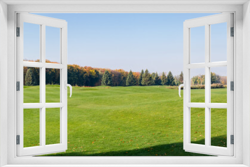 Fototapeta Naklejka Na Ścianę Okno 3D - Panoramic view of large lawn against autumn forest and sky