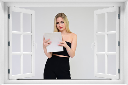 Business training concept with a girl. Portrait of a fashionable beautiful blonde model with long hair, excellent makeup, on a white background with a folder in her hands.