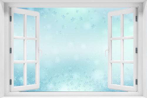 Blue bokeh background. Christmas glowing lights with sparkles and snowflakes. Holiday decorative effect.