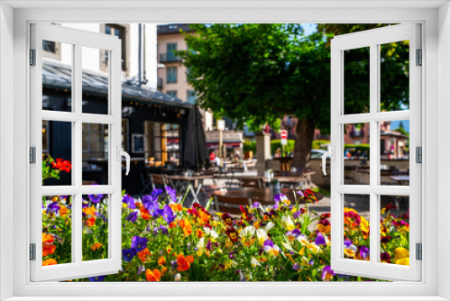 Fototapeta Naklejka Na Ścianę Okno 3D - Cozy street with tables of cafe old town street in Chamonix village, France. Architecture and landmark. Cozy cityscape. Typical view of the street with tables of cafe in Chamonix.