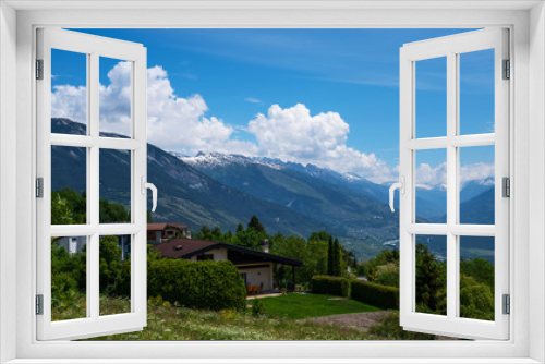 Fototapeta Naklejka Na Ścianę Okno 3D - Stunning alpine panorama colorful summer view. Beautiful outdoor scene Switzerland, Europe. Hazy blue mountains. Alpine houses, meadows on the slopes and snow-capped mountains.