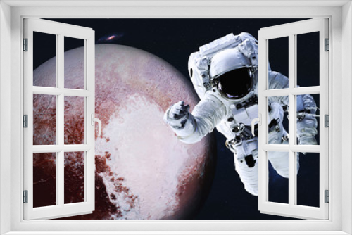 Fototapeta Naklejka Na Ścianę Okno 3D - Astronaut near Planet Pluto of Solar system in space with far galaxy on the background. Science fiction. Spaccewalk concept. Elements of this image were furnished by NASA 