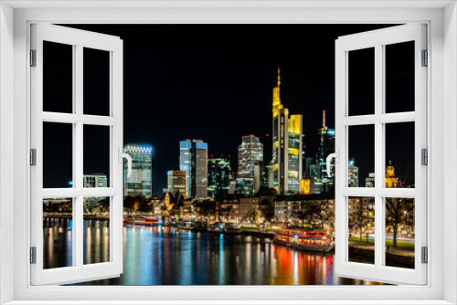 frankfurt skyline at night with colorful reflections in the main river, frankfurt am main, germany