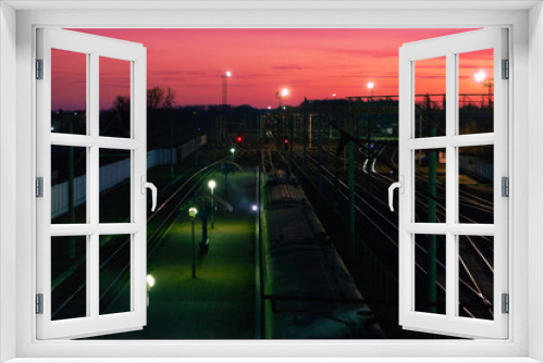 Fototapeta Naklejka Na Ścianę Okno 3D - Railways at the sunset. Orange sunset in low clouds over railroad top view. Early morning 