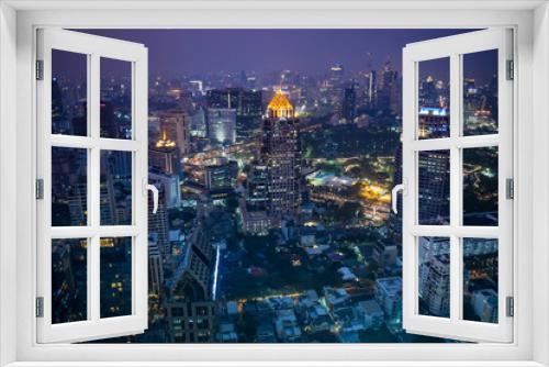 Fototapeta Naklejka Na Ścianę Okno 3D - The enlightened skyscrapers of Bangkok skyline during night in Thailand