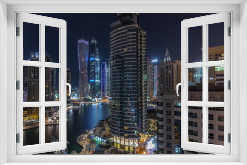 Fototapeta Naklejka Na Ścianę Okno 3D - Aerial view of Dubai Marina residential and office skyscrapers with waterfront night timelapse