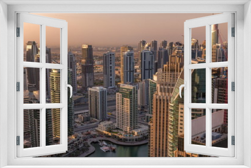 Fototapeta Naklejka Na Ścianę Okno 3D - Dubai Marina skyscrapers and jumeirah lake towers sunrise view from the top aerial timelapse in the United Arab Emirates.