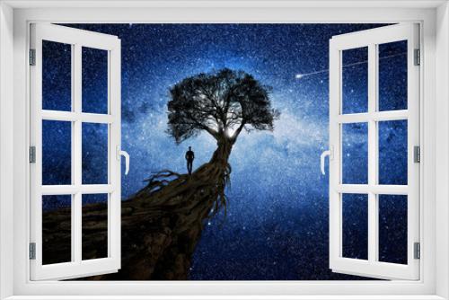 Fototapeta Naklejka Na Ścianę Okno 3D - Man under a tree in front of the universe