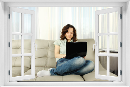 Young Woman on Couch with Laptop